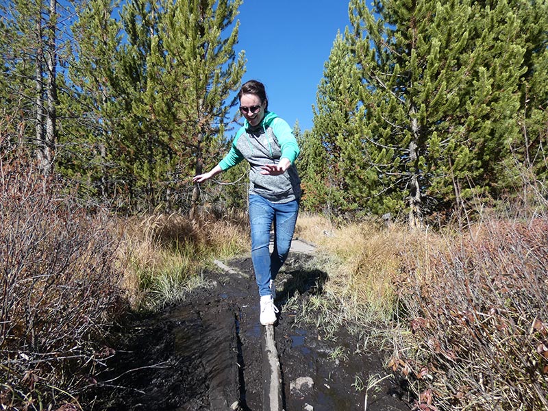 girl-sliding-while-on-hike-of-the-yellowstone-imperial-geyser